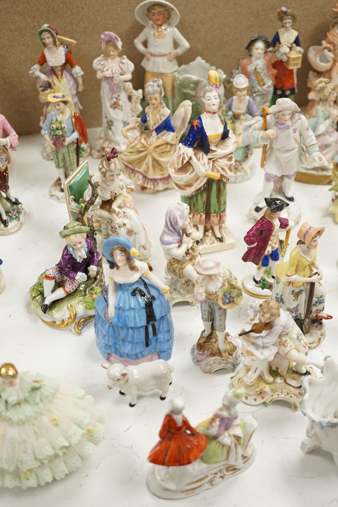 A large collection of small to medium German, French and English porcelain figurines and groups, tallest 18cm